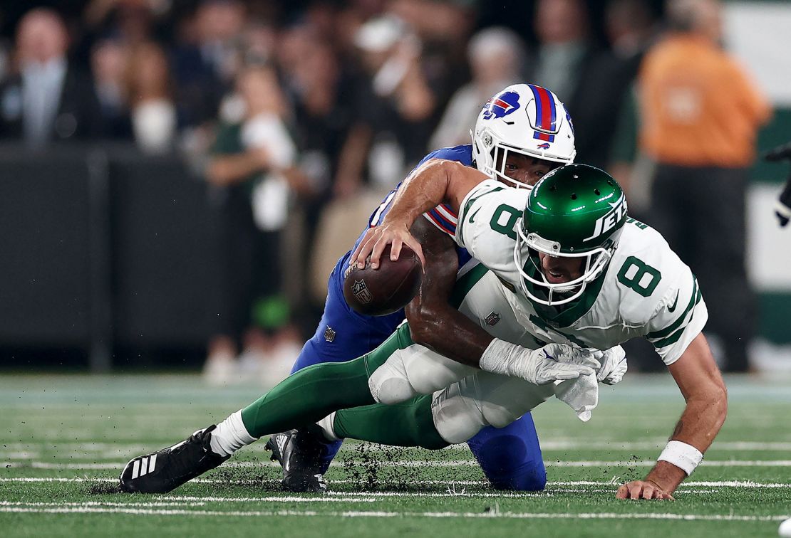 EAST RUTHERFORD, NEW JERSEY - SEPTEMBER 11: Aaron Rodgers #8 of the New York Jets is sacked by Leonard Floyd #56 of the Buffalo Bills in the first quarter at MetLife Stadium on September 11, 2023 in East Rutherford, New Jersey. Rodgers was helped off the field after this play. (Photo by Elsa/Getty Images)