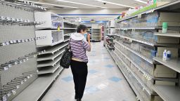A woman browses through what items remain on near empty shelves at a Rite Aid store in Alhambra, California, on October 18, 2023, that is due for closure next Monday. The US pharmacy chain this week filed for Chapter 11 and plans to close almost 100 stores nationwide, including 31 in California, as part of its restructuring plan after filing for bankruptcy. (Photo by Frederic J. BROWN / AFP) (Photo by FREDERIC J. BROWN/AFP via Getty Images)