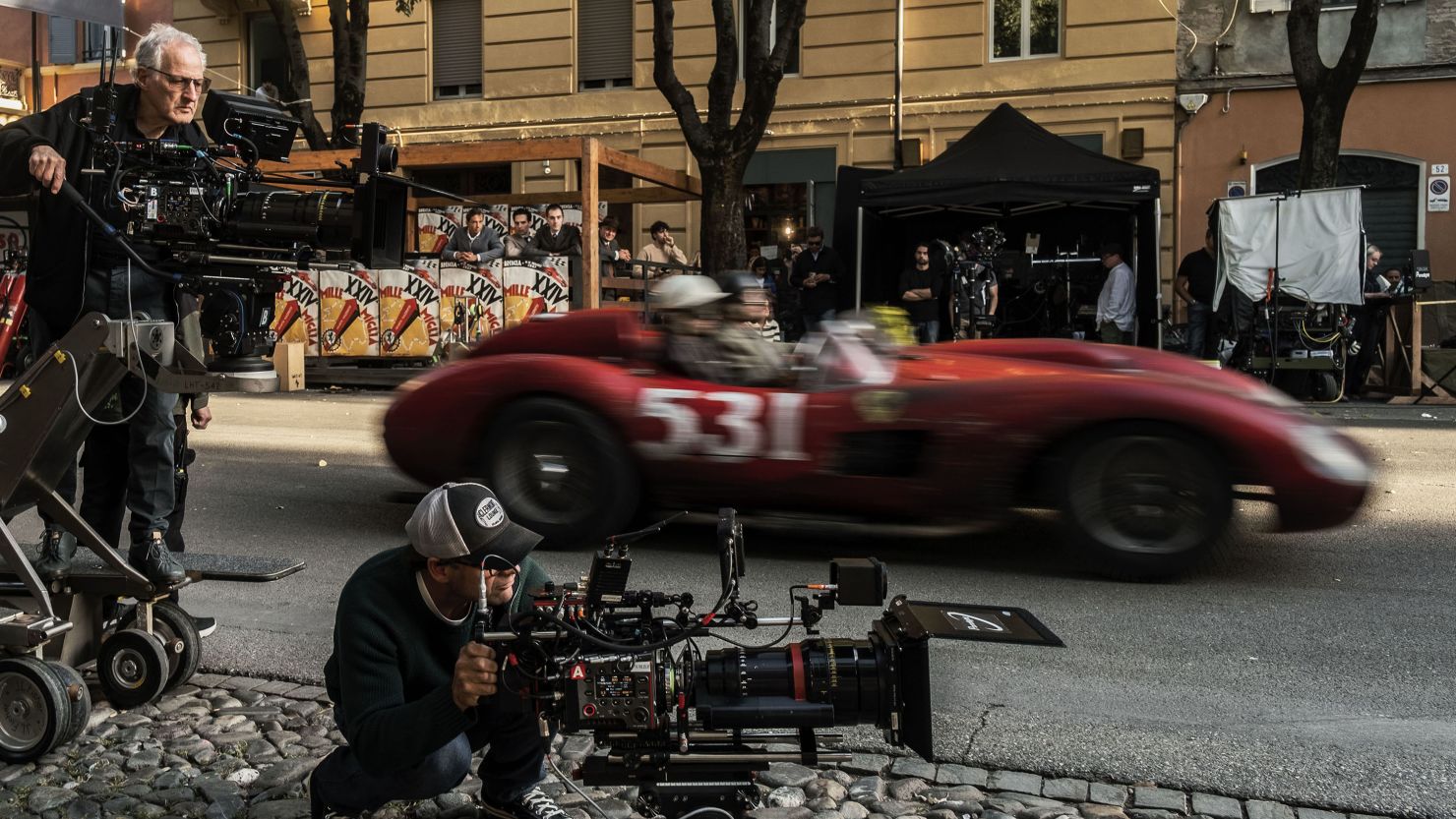 Michael Mann (left) directs a racing sequence on location in Modena, Italy during the production of "Ferrari."