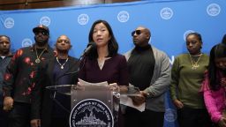 Boston Mayor Michelle Wu, center, issues a formal apology to Alan Swanson and Willie Bennett, Wednesday, Dec. 20, 2023, during a news conference, in Boston, for their wrongful arrests following the 1989 death of Carol Stuart, whose husband, Charles Stuart, had orchestrated her murder. (AP Photo/Steven Senne)