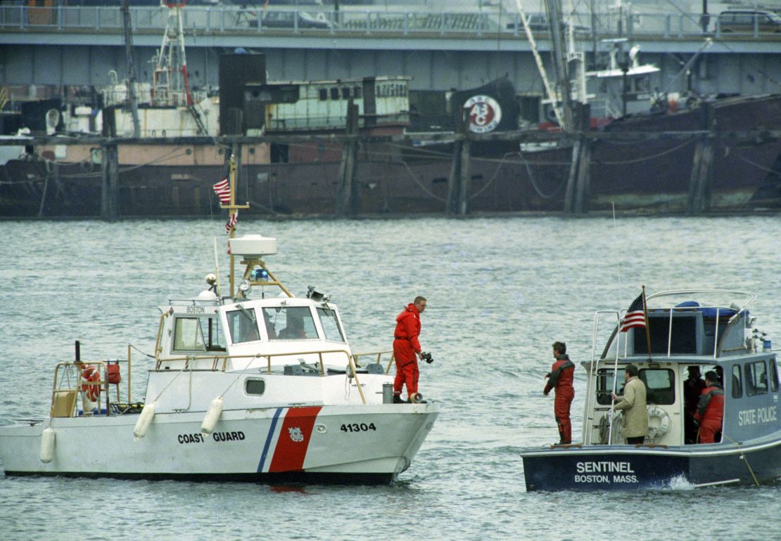 FILE - Boston Police and Coast Guard boats search the water for the body of Charles Stuart, who police believed jumped from the Tobin Bridge in Boston, Jan. 4, 1990. On Wednesday, Dec. 20, 2023, Boston Mayor Michelle Wu plans to formally apologize on behalf of the city to Alan Swanson and Willie Bennett for their wrongful arrests following the 1989 death of Carol Stuart, whose husband, Charles Stuart, had orchestrated her killing. Stuart blamed his wife's killing — and his own shooting during what he portrayed as an attempted carjacking — on an unidentified Black gunman, leading to a crackdown by police in one of the city's traditionally Black neighborhoods in pursuit of a phantom assailant. (AP Photo/Elise Amendola, File)