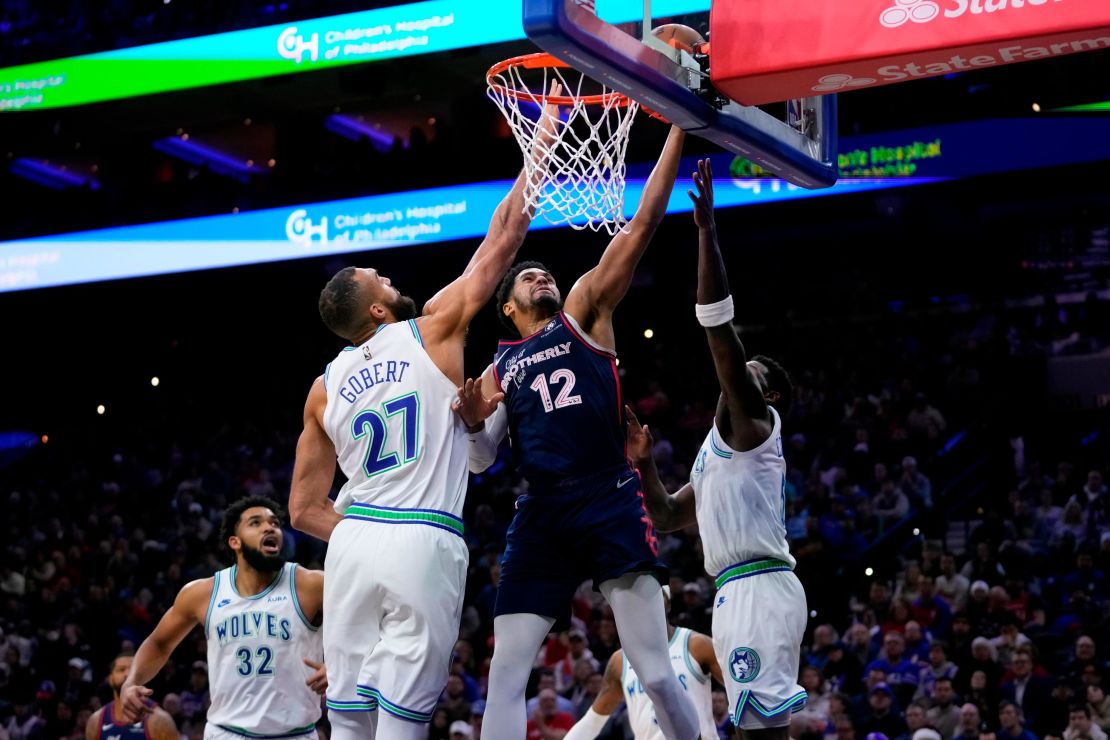 Philadelphia 76ers' Tobias Harris (12) goes up for a shot against Minnesota Timberwolves' Rudy Gobert (27) and Anthony Edwards (5) during the second half of an NBA basketball game, Wednesday, Dec. 20, 2023, in Philadelphia.