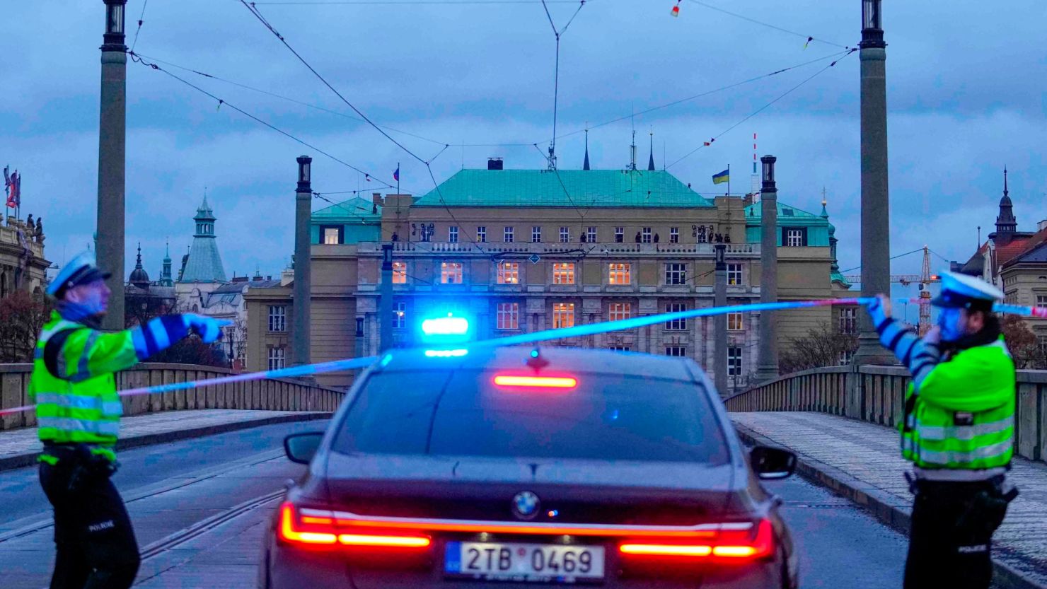 Police officers guard a street in downtown Prague, Czech Republic, Thursday, Dec. 21, 2023. Czech police say a shooting in downtown Prague has killed an unspecified number of people and wounded others.