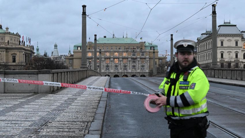 A police officer cordon off an area near the university in central Prague, on December 21, 2023. Czech police said Thursday a shooting in a university building in central Prague has left "dead and wounded people", without providing further details.