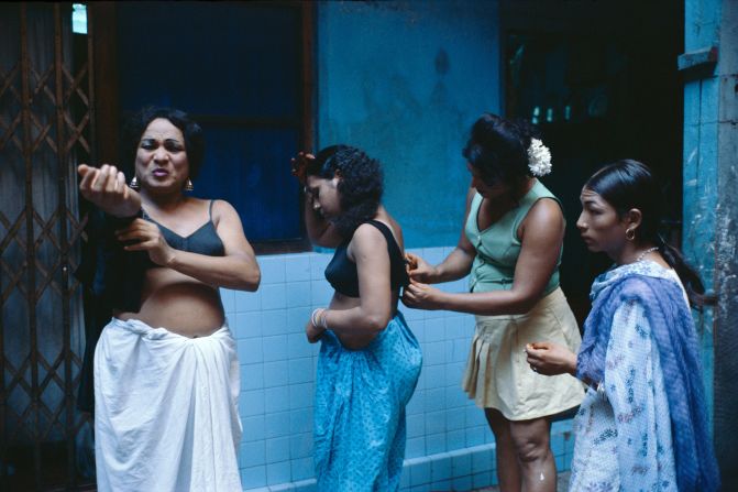 Trans sex workers getting dressed in a courtyard. 