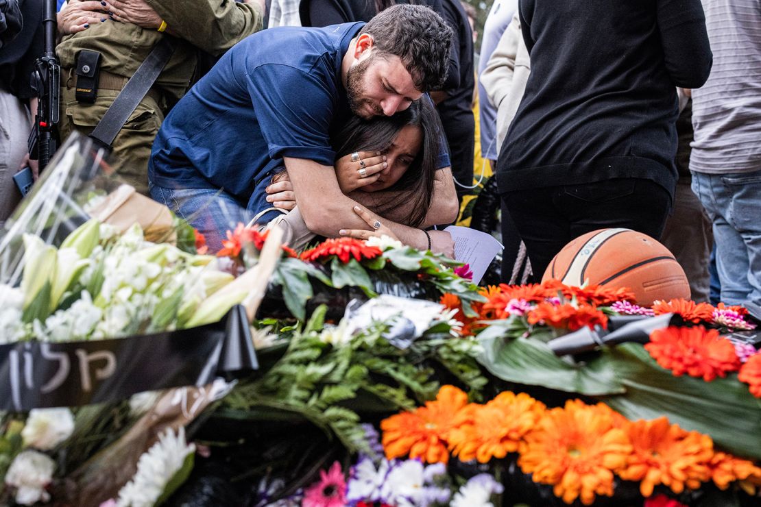 Relatives and friends mourn as they gather for the funeral of Alon Shamriz, mistakenly killed by Israeli forces in Gaza earlier in the week after being held by Hamas since the October 7 attack, in kibbutz Shefayim near Tel Aviv on December 17, 2023.