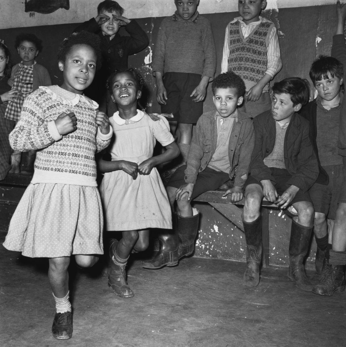 A group of children playing indoors in the Bute Town area of Cardiff, Wales, April 1950. Several boys wear Wellington boots and a couple of the children wear Fair Isle pattern knitted tops. Original Publication: Picture Post - 5020 - Down The Bay - pub. 22nd April 1950 (Photo by Bert Hardy/Picture Post/Hulton Archive/Getty Images)