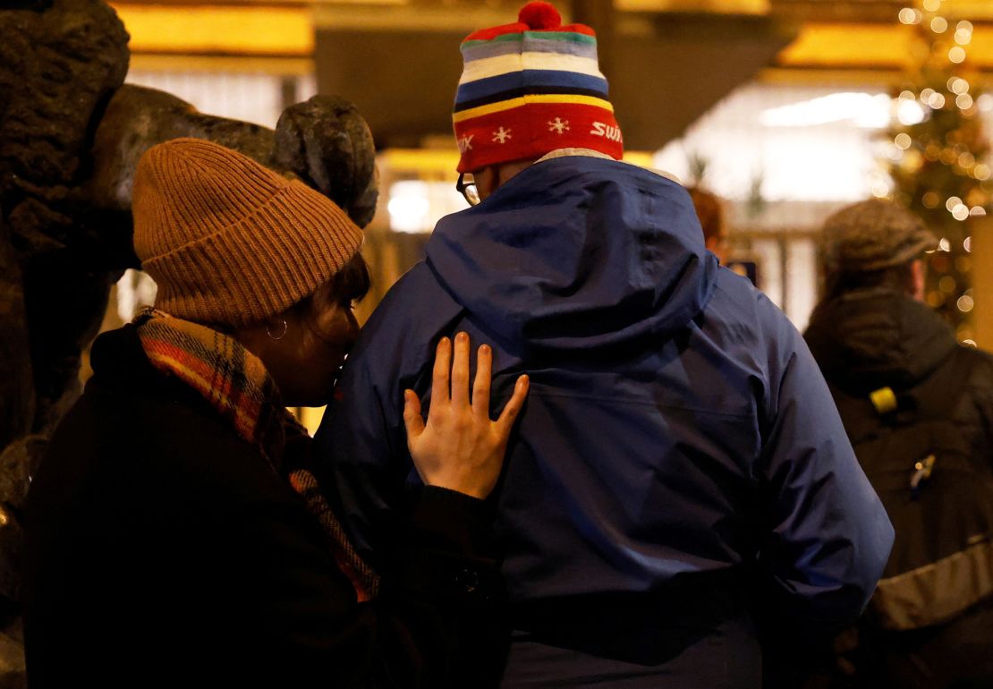 People embrace in front of Charles University main building following the shooting at one of its buildings in Prague, Czech Republic, December 21, 2023. REUTERS/David W Cerny