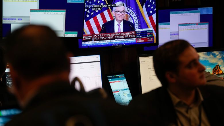 A monitor displays a news conference with Federal Reserve chairman Jerome Powell as traders work on the floor at the New York Stock Exchange in New York, Wednesday, June 14, 2023. The Federal Reserve kept its key interest rate unchanged after having raised it 10 straight times to combat high inflation. But in a surprise move, the Fed signaled that it may raise rates twice more this year, beginning as soon as next month.