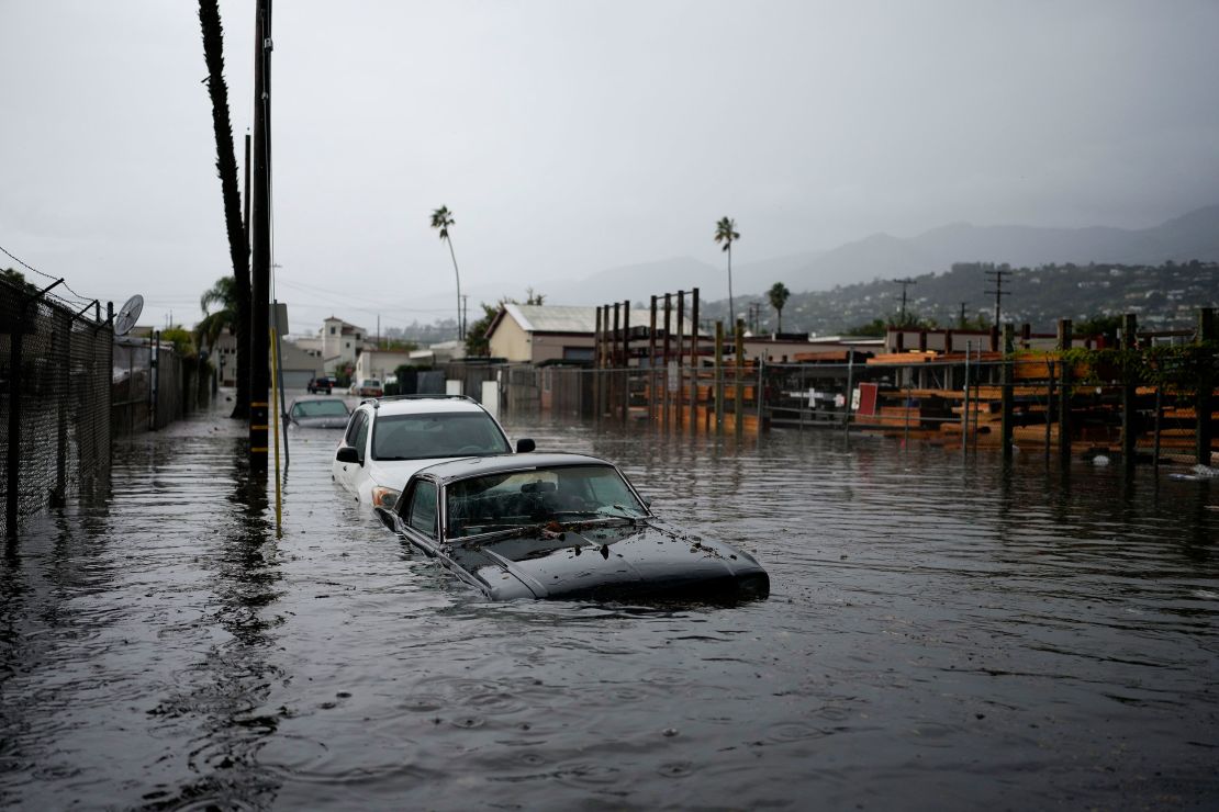 Cars are submerged on a flooded street during a rainstorm in Santa Barbara, California.