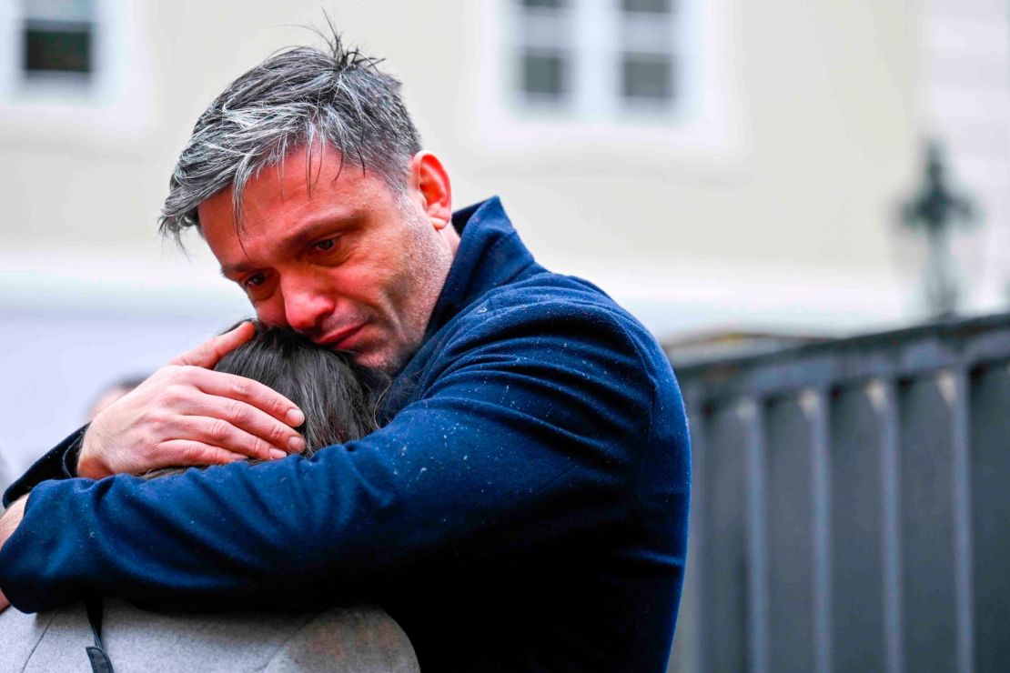 Mourners hug outside the headquarters of Charles University after a mass shooting in Prague, Czech Republic, Friday, Dec. 22, 2023. A lone gunman opened fire at a university on Thursday, killing more than a dozen people and injuring scores of people.