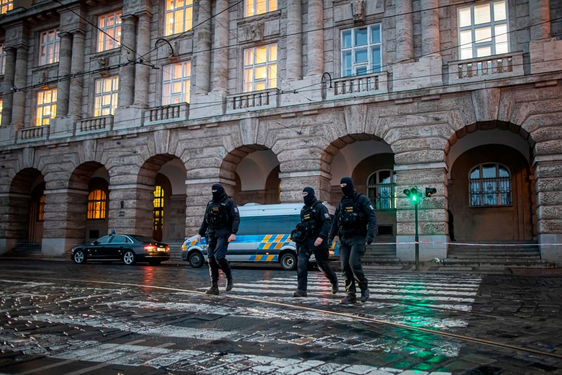 Police officers walk out the building of Philosophical Faculty of Charles University where a mass shooting took place on December 22, 2023 in Prague, Czech Republic.