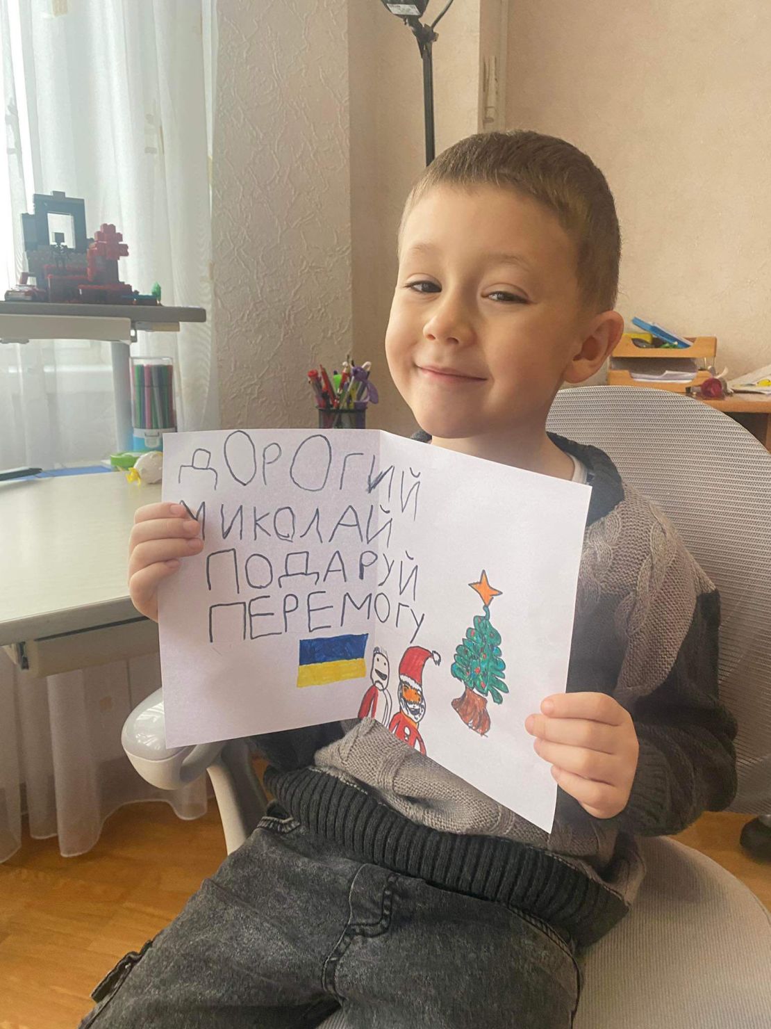 Maks, 5 years old. Five year old Maks wants victory for Christmas. His letter is simple and short: "Dear Nicholas, bring us victory" His mother says Maks picked up his strong patriotism and the importance of Ukraine's victory from overhearing adult conversations. The family left Kyiv when the war started for western Ukraine. He left his letter for St Nicholas on the window sill of their temporary new home.