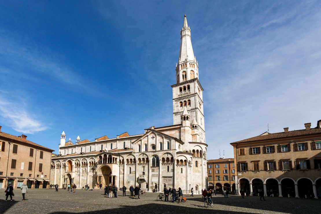 Modena, Italy - March 5, 2017: The UNESCO World Heritage-listed Modena Cathedral and Ghirlandina Tower on the Piazza Grande, Modena, Italy.