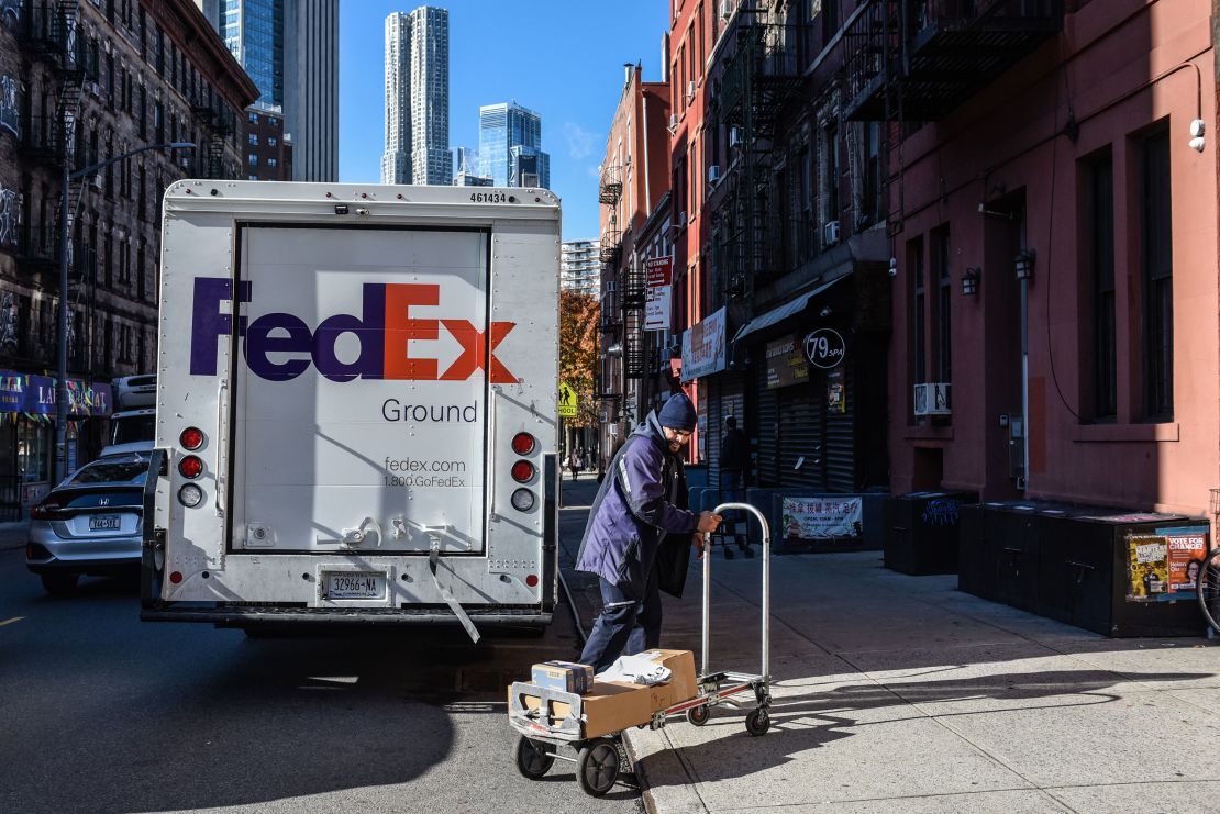 A driver for an independent contractor to FedEx delivers packages in New York on November 27