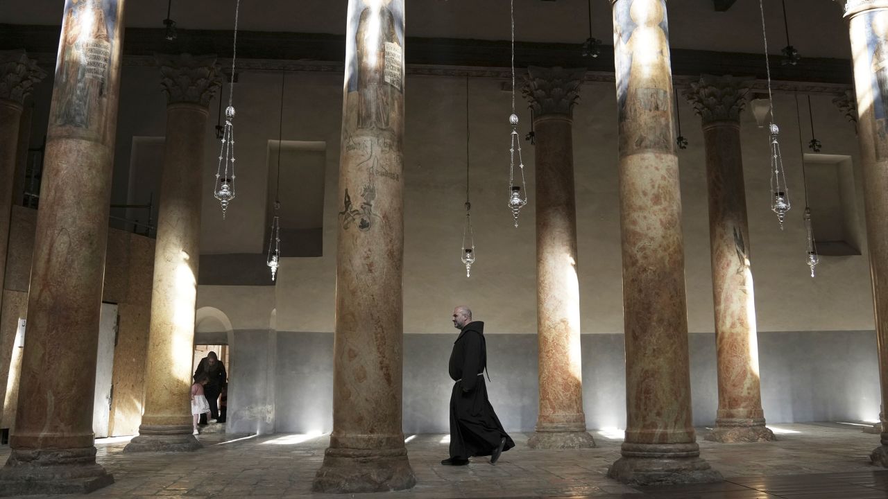 A priest walks at the Church of the Nativity, traditionally believed to be the birthplace of Jesus Christ in the West Bank town of Bethlehem, Saturday, Dec. 16, 2023. World-famous Christmas celebrations in Bethlehem have been put on hold due to the ongoing Israel-Hamas war. (AP Photo/Mahmoud Illean)