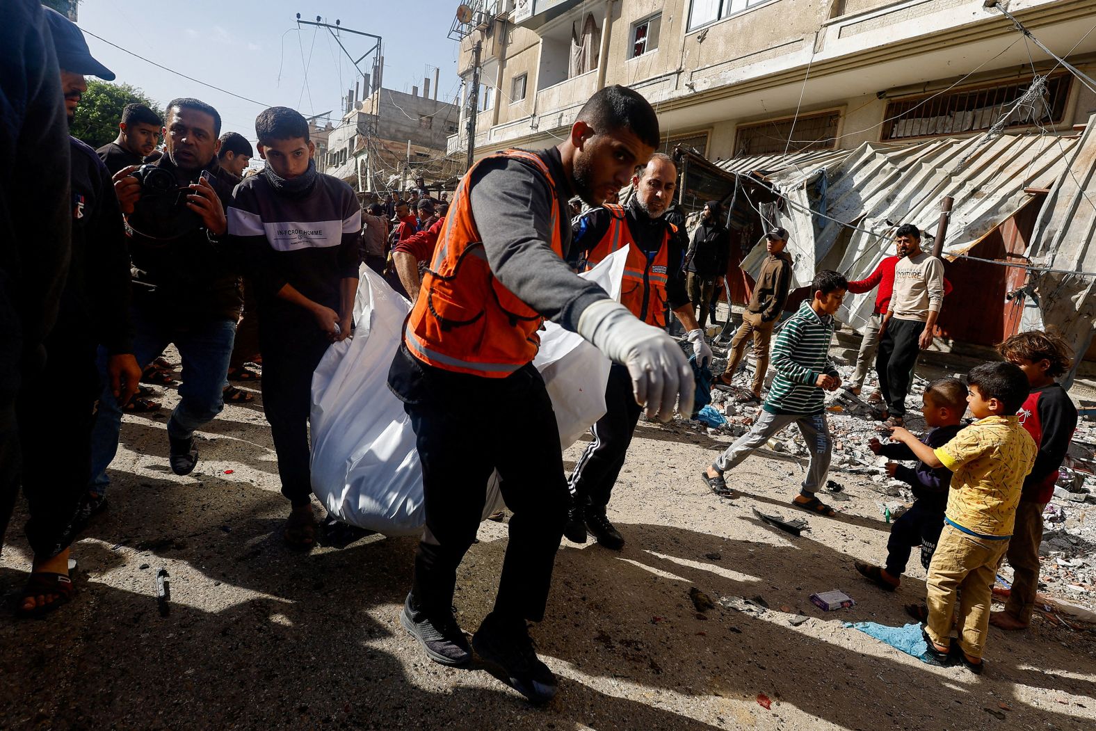 Palestinians carry a casualty near the site of an Israeli strike in Rafah, Gaza, on December 22.