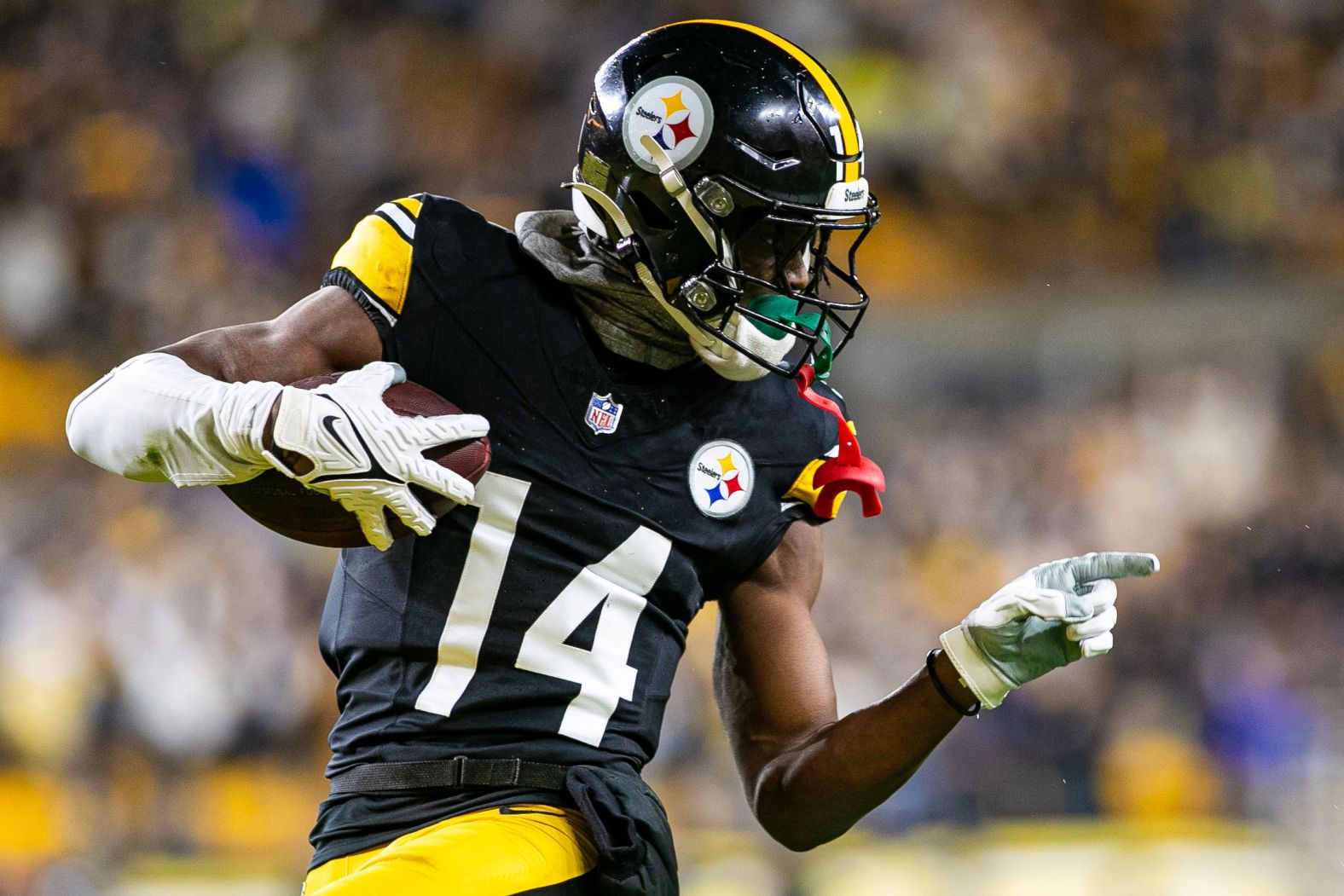 Pittsburgh Steelers wide receiver George Pickens points to a Cincinnati Bengals defender as he runs by during the Steelers' 34-11 win against the Bengals on Saturday, December 23. 