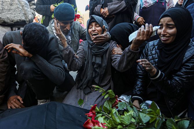 Mourners collect the bodies of Palestinians killed in an Israeli airstrike in Khan Younis, Gaza, on December 24.