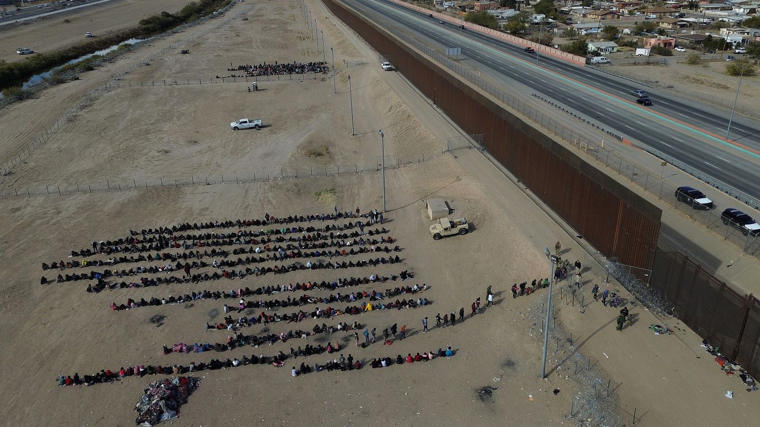 Aerial view showing migrants queuing at the border fence in an attempt to cross into the United States in Ciudad Juarez Chihuahua, Mexico, on 19 December 2023. Texas' new anti-migrant law is causing fear among the growing number of migrants stranded in Ciudad Juarez, on Mexico's northern border, where undocumented migrants fear it will make it even more difficult for them to cross into the United States.