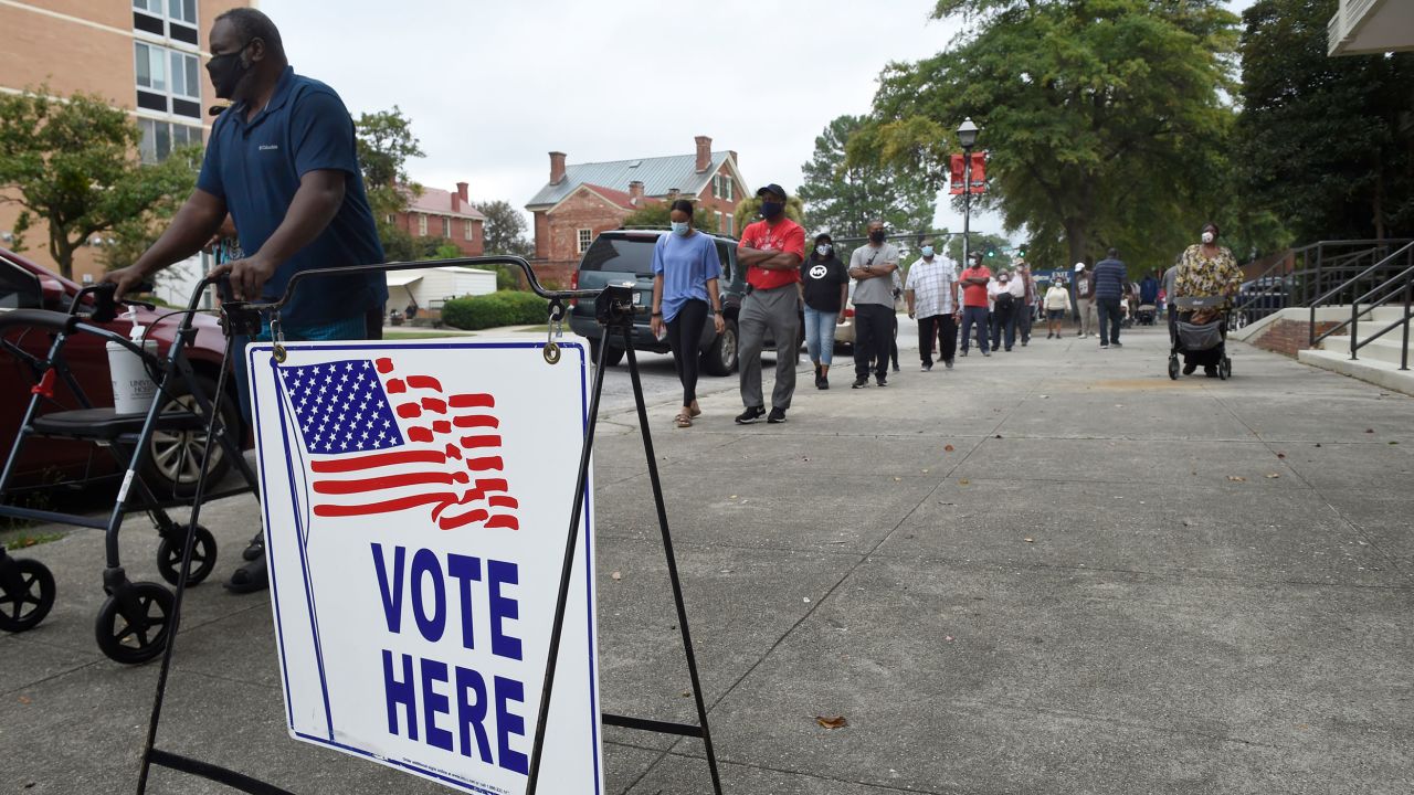 FILE -In this Oct. 12, 2020 file photo, voters wait in line to cast their ballot during early voting at the Bell Auditorium in Augusta, Ga. Fueled by Black turnout, Democrats scored stunning wins in the once reliably red state for president and U.S. Senate in the last election cycle. Republican lawmakers are now forging ahead with an aggressive slate of voting legislation that critics argue is tailored toward curtailing the power of Black voters. (Michael Holahan/The Augusta Chronicle via AP, File)