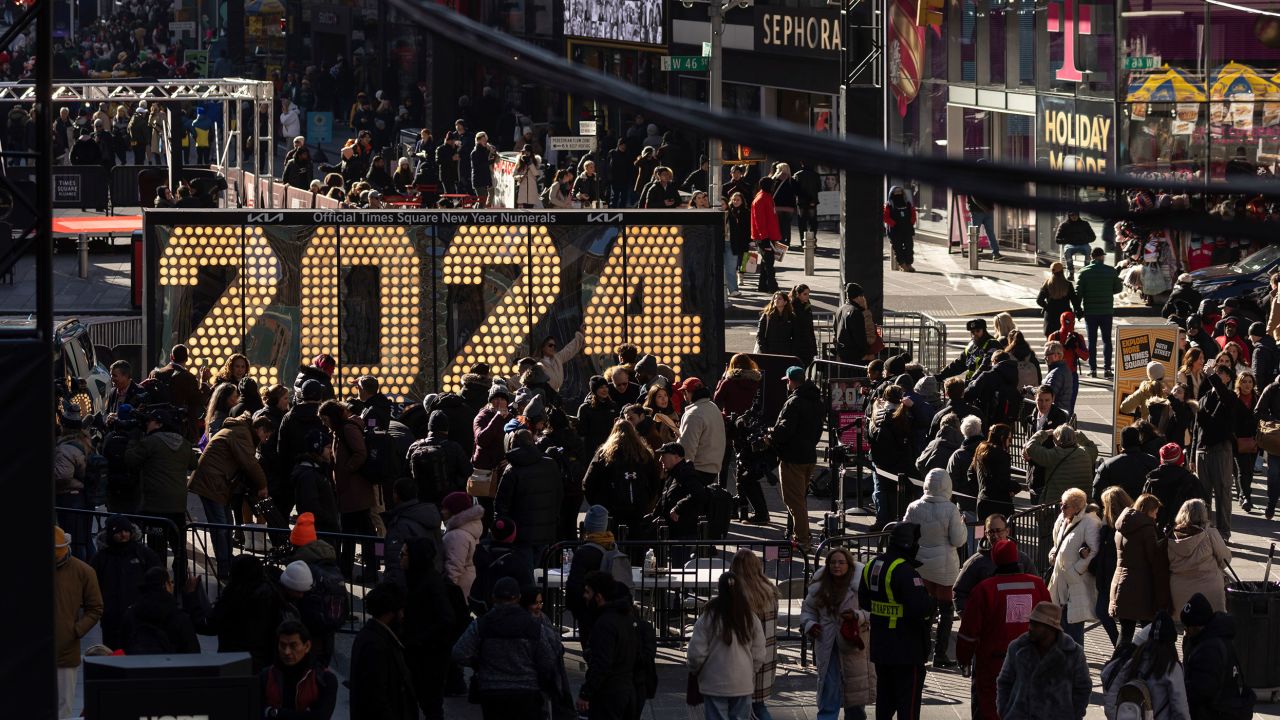 People gather around the 2024 New Year's Eve numerals displayed in Times Square, Wednesday, Dec. 20, 2023, in New York. (AP Photo/Yuki Iwamura)