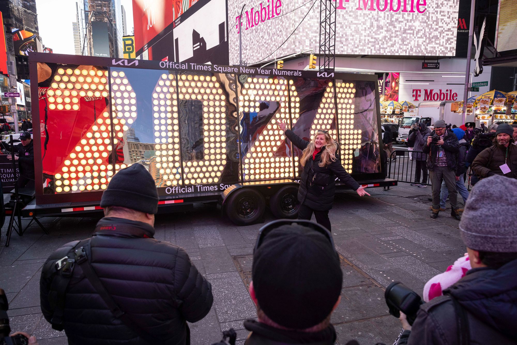 People pose in front of the 2024 New Year's Eve numerals are displayed in Times Square, Wednesday, Dec. 20, 2023, in New York. (AP Photo/Yuki Iwamura)