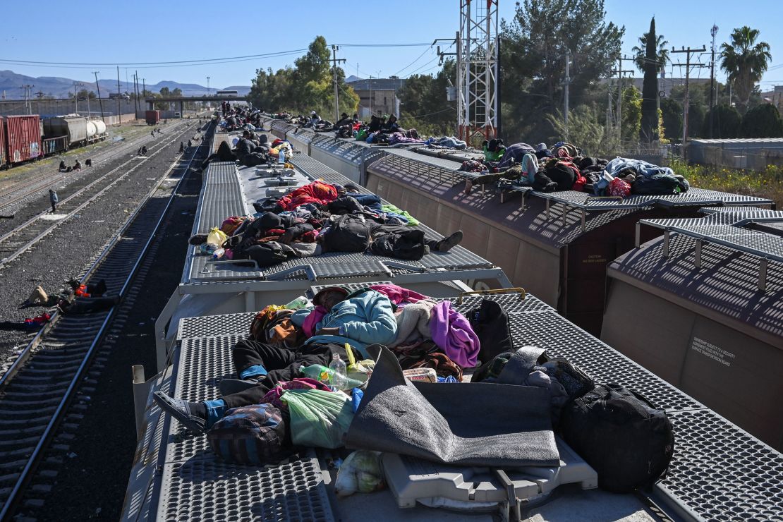 Migrants rest on railroad cars as they wait for a freight train to travel to the U.S. border, at a rail yard in Chihuahua, Mexico December 26, 2023. REUTERS/Raul Fernando Perez Lira NO RESALES. NO ARCHIVES