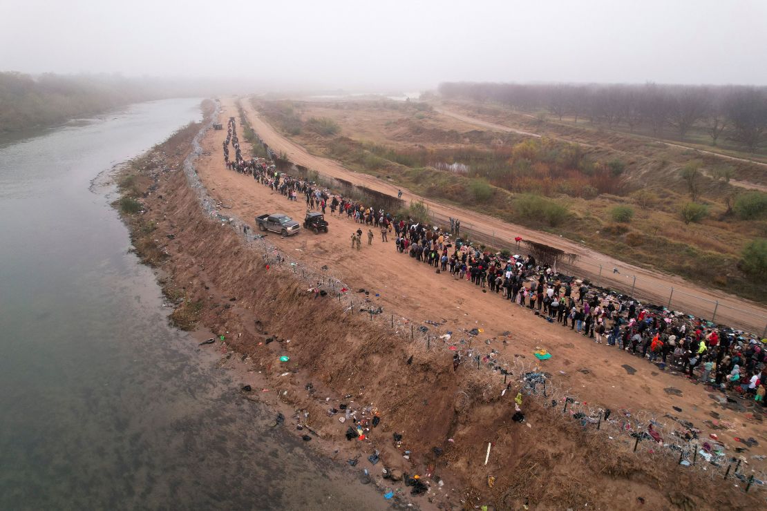 Migrants gather near the border in Eagle Pass after crossing the Rio Bravo river with the intention of turning themselves in to the U.S. Border Patrol agents to request asylum, as seen from Piedras Negras, Coahuila, Mexico December 23, 2023. REUTERS/Jose Luis Gonzalez