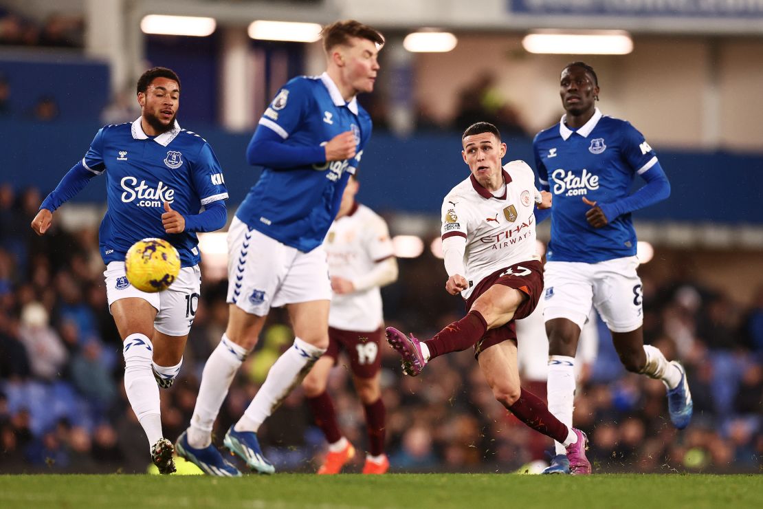 LIVERPOOL, ENGLAND - DECEMBER 27: Phil Foden of Manchester City takes a shot whilst under pressure from Arnaut Danjuma of Everton during the Premier League match between Everton FC and Manchester City at Goodison Park on December 27, 2023 in Liverpool, England. (Photo by Naomi Baker/Getty Images)