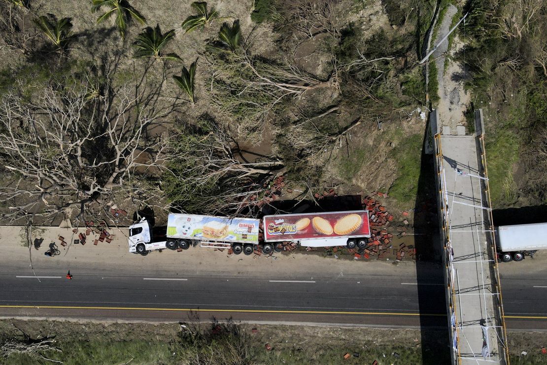 An overturned semi lays on the shoulder of a highway in the aftermath of Hurricane Otis, on the outskirts of Acapulco, Mexico, Friday, Oct. 27, 2023.