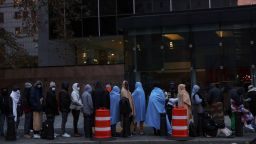 Immigrants stand waiting in line outside the Federal Plaza Immigration Court in New York City, U.S., November 6, 2023.  REUTERS/Shannon Stapleton