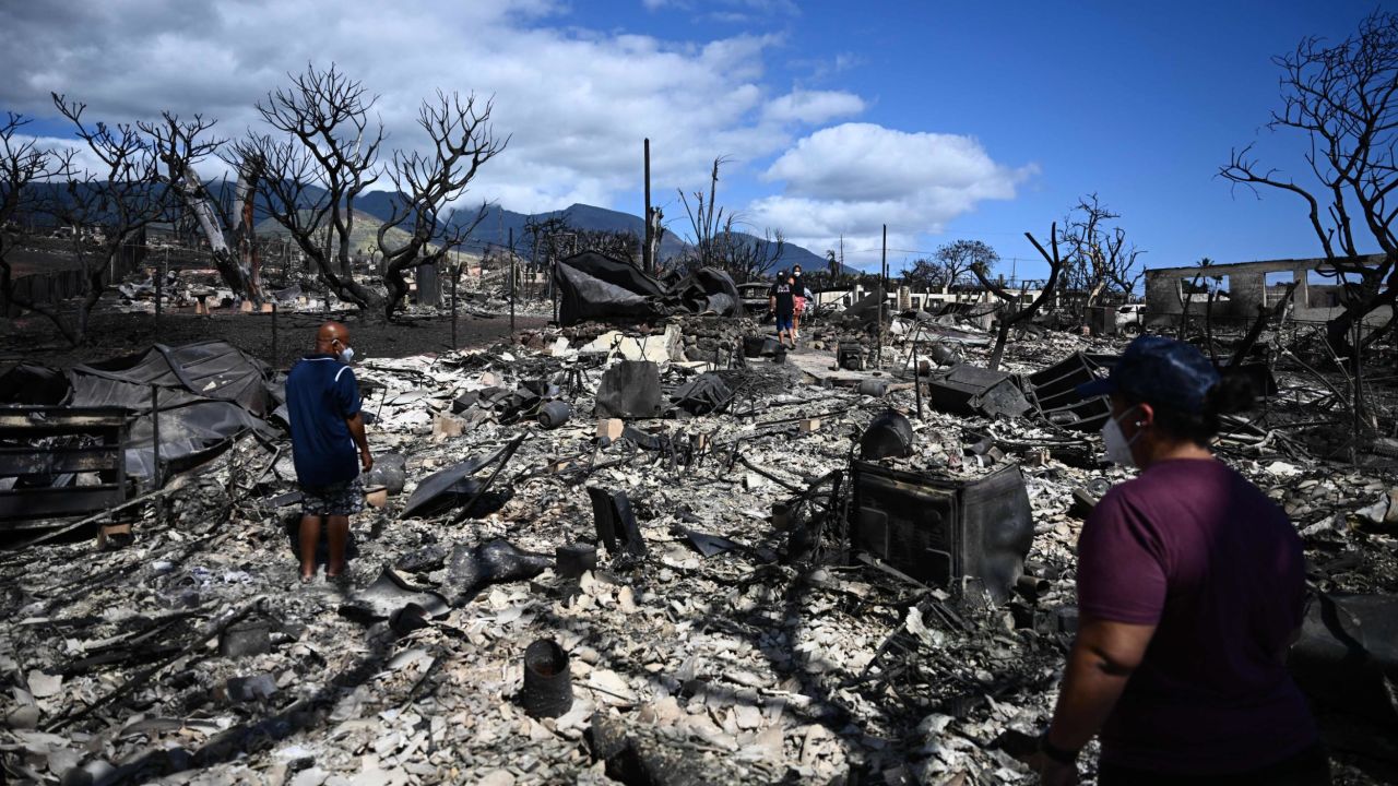 The Ganer family look through the ashes of their family's home on Malolo Place in the aftermath of a wildfire in Lahaina, western Maui, Hawaii on August 11, 2023.