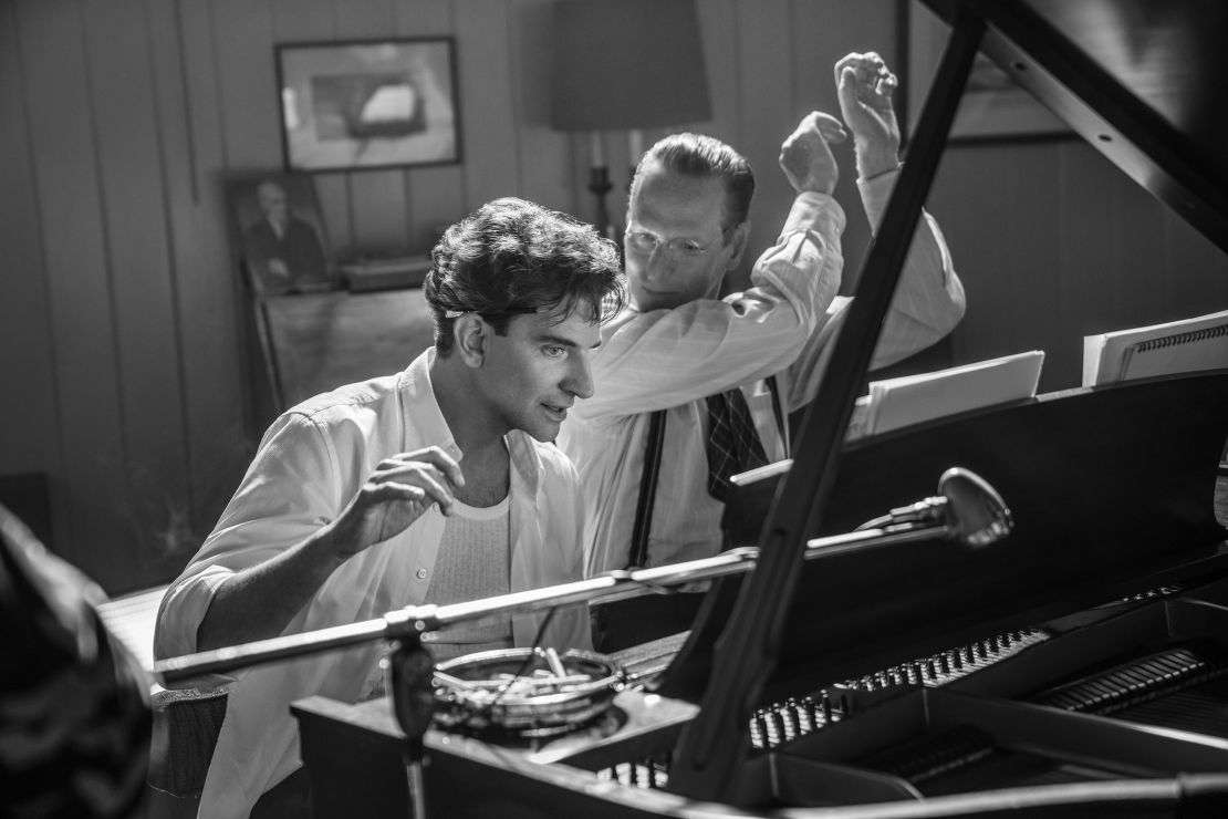 Maestro. (L to R) Bradley Cooper as Leonard Bernstein (Director/Writer/Producer), and Brian Klugman as Aaron Copland in Maestro.