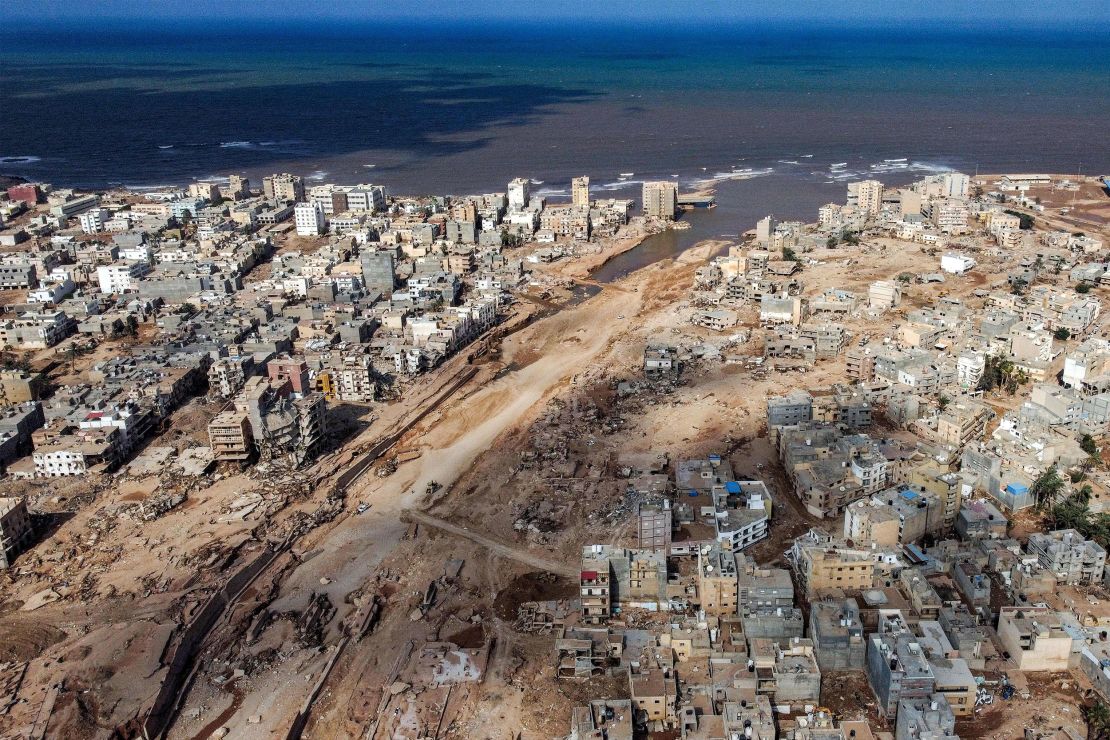 An aerial view shows Libya's eastern city of Derna on September 18, 2023, following deadly flash floods. A week after a tsunami-sized flash flood devastated the Libyan coastal city of Derna, sweeping thousands to their deaths, the international aid effort to help the grieving survivors slowly gathered pace. The enormous flood, fuelled by torrential rains on September 10, had broken through two upstream dams and sent a giant wave crashing down the previously dry river bed, or wadi, that bisects the city of about 100,000 people. (Photo by Mahmud TURKIA / AFP) (Photo by MAHMUD TURKIA/AFP via Getty Images)