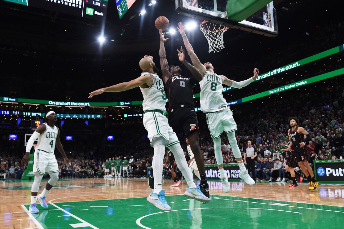 Dec 28, 2023; Boston, Massachusetts, USA;  Boston Celtics guard Derrick White (9) Detroit Pistons center Jalen Duren (0) and center Kristaps Porzingis (8) battle for a rebound during overtime at TD Garden.