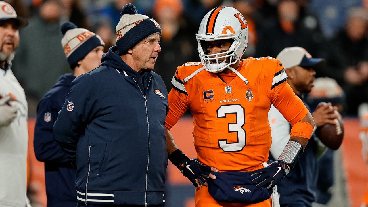 Dec 24, 2023; Denver, Colorado, USA; Denver Broncos head coach Sean Payton talks with quarterback Russell Wilson (3) before the game against the New England Patriots at Empower Field at Mile High.