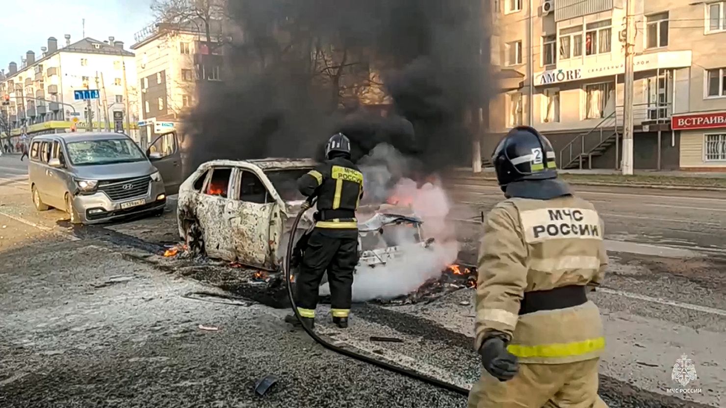 In this photo taken from video released by Russia Emergency Situations Ministry telegram channel on Saturday, Dec. 30, 2023, Firefighters extinguish burning cars after shelling in Belgorod, Russia.