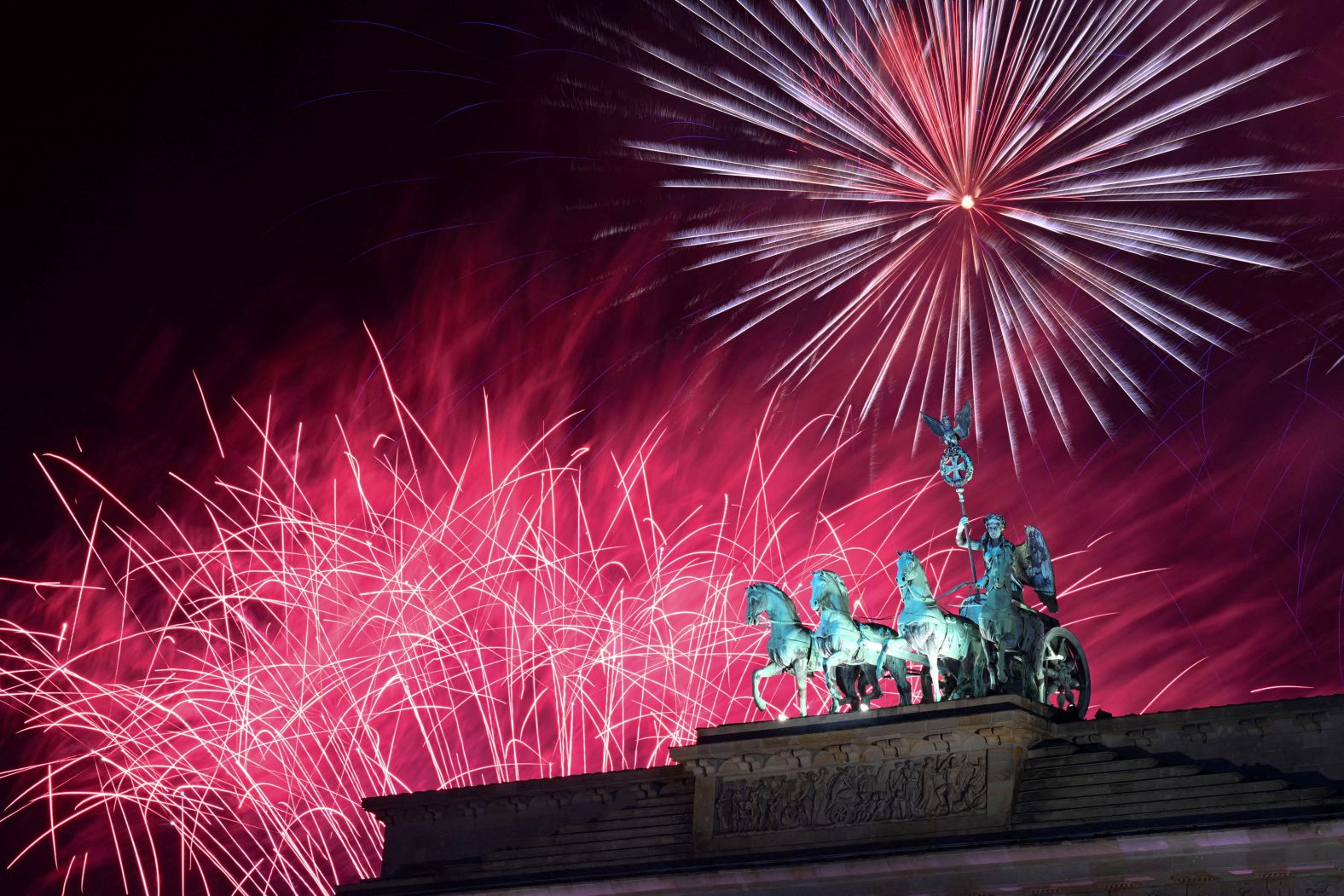Fireworks illuminate the Brandenburg Gate in Berlin, Germany.