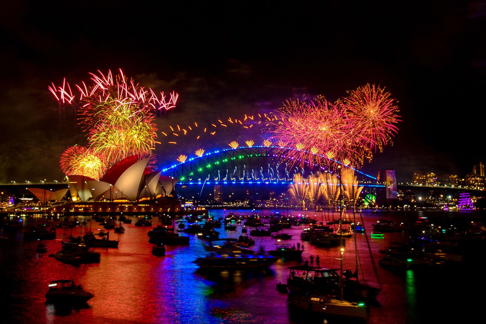 Fireworks explode over the Sydney Opera House and Sydney Harbour Bridge.