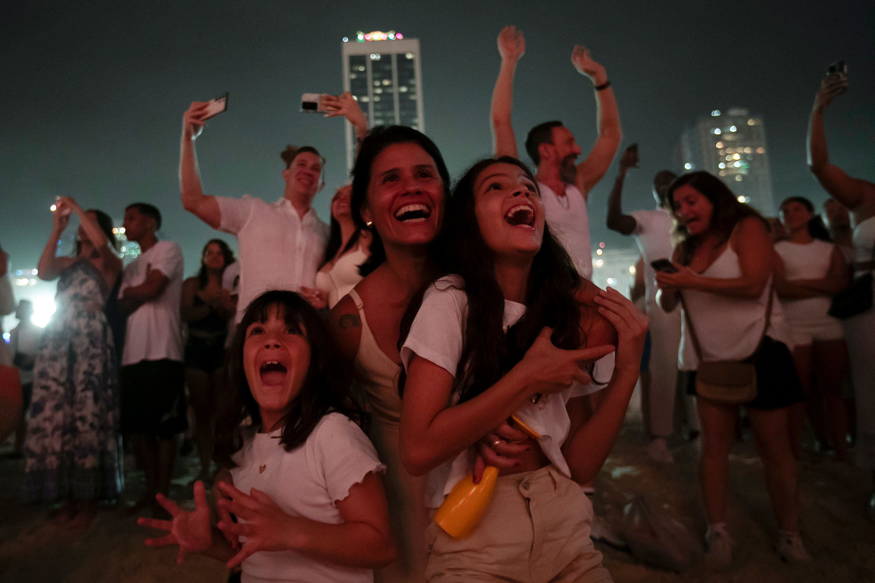 People watch fireworks light up Copacabana Beach in Rio de Janeiro, Brazil.