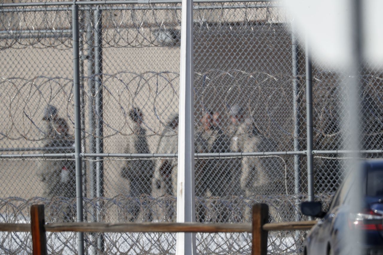 Prisoners stand outside a federal correctional institution in Englewood, Colorado, on February 18.