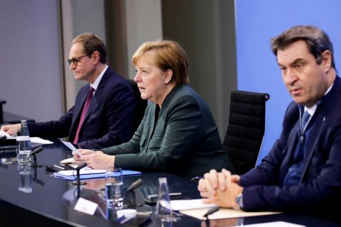 Berlin's Mayor Michael Mueller, left, German Chancellor Angela Merkel, center, and Bavaria's State Premier Markus Soeder attend a press conference at the Chancellery in Berlin on January 19.