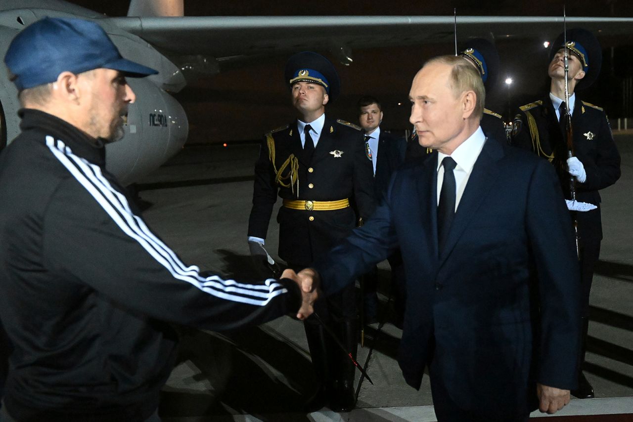 Russian President Vladimir Putin greets Vadim Krasikov upon arrival following his release, at Vnukovo government airport outside Moscow, Russia, on August 1.