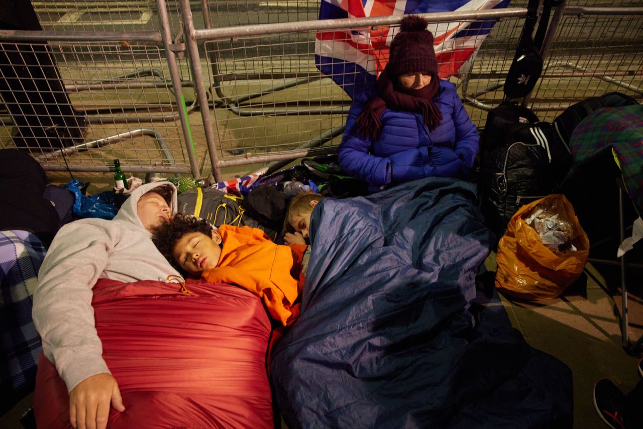 Early crowds gather in anticipation of the funeral of Queen Elizabeth II in Whitehall, London on Monday morning.