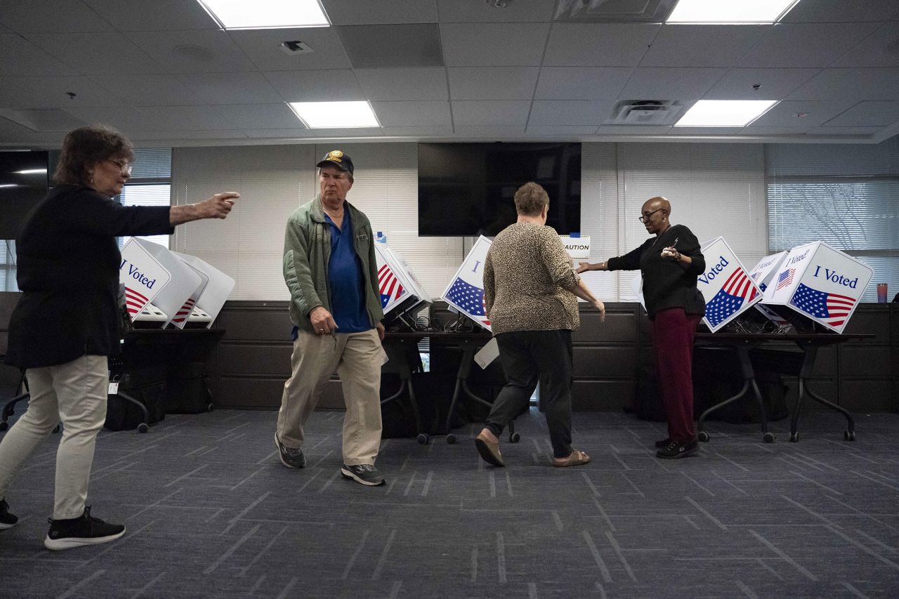 Election officials direct voters during the first day of early voting at a polling station in Charleston, South Carolina, on Monday, February 12.