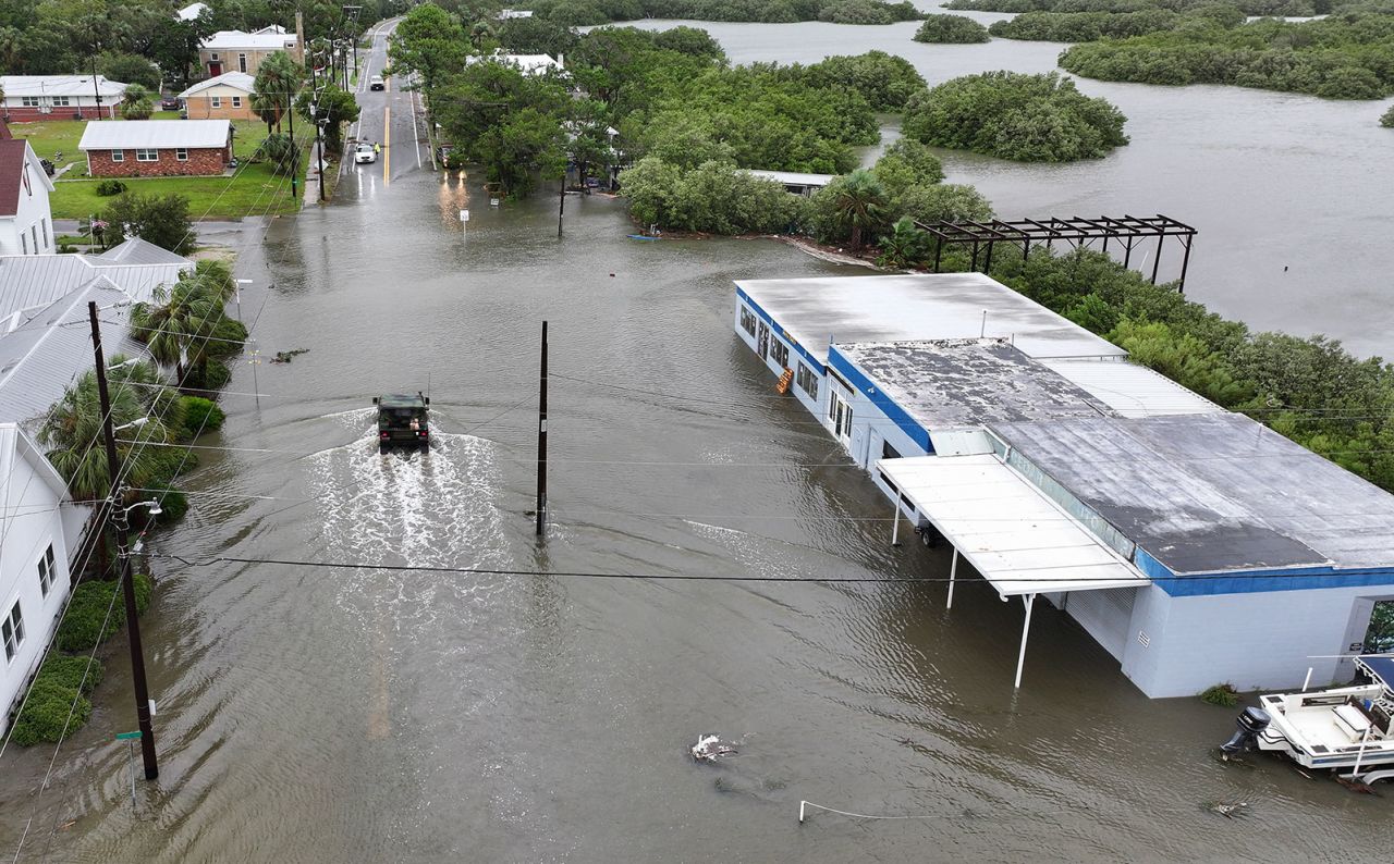 A Florida National Guard vehicle drives through a flooded street from the rain and storm surge caused by Debby on August 5 in Cedar Key, Florida. 