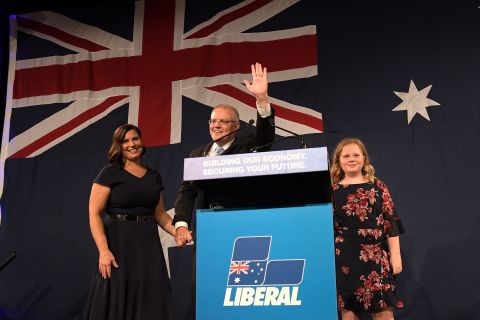 Prime Minister Scott Morrison, flanked by his wife Jenny Morrison and daughters Lily Morrison and Abbey Morrison, delivers his victory speech in Sydney on Saturday.