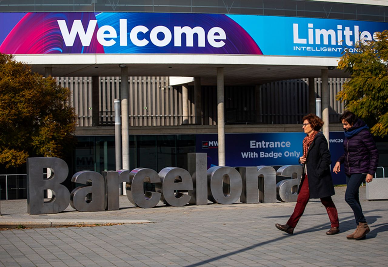 People walk past posters announcing the Mobile World Congress 2020 in a conference venue in Barcelona, Spain, Tuesday, February 11.? The organizer of the event announced that it would be cancelled in a segment on Wednesday. 