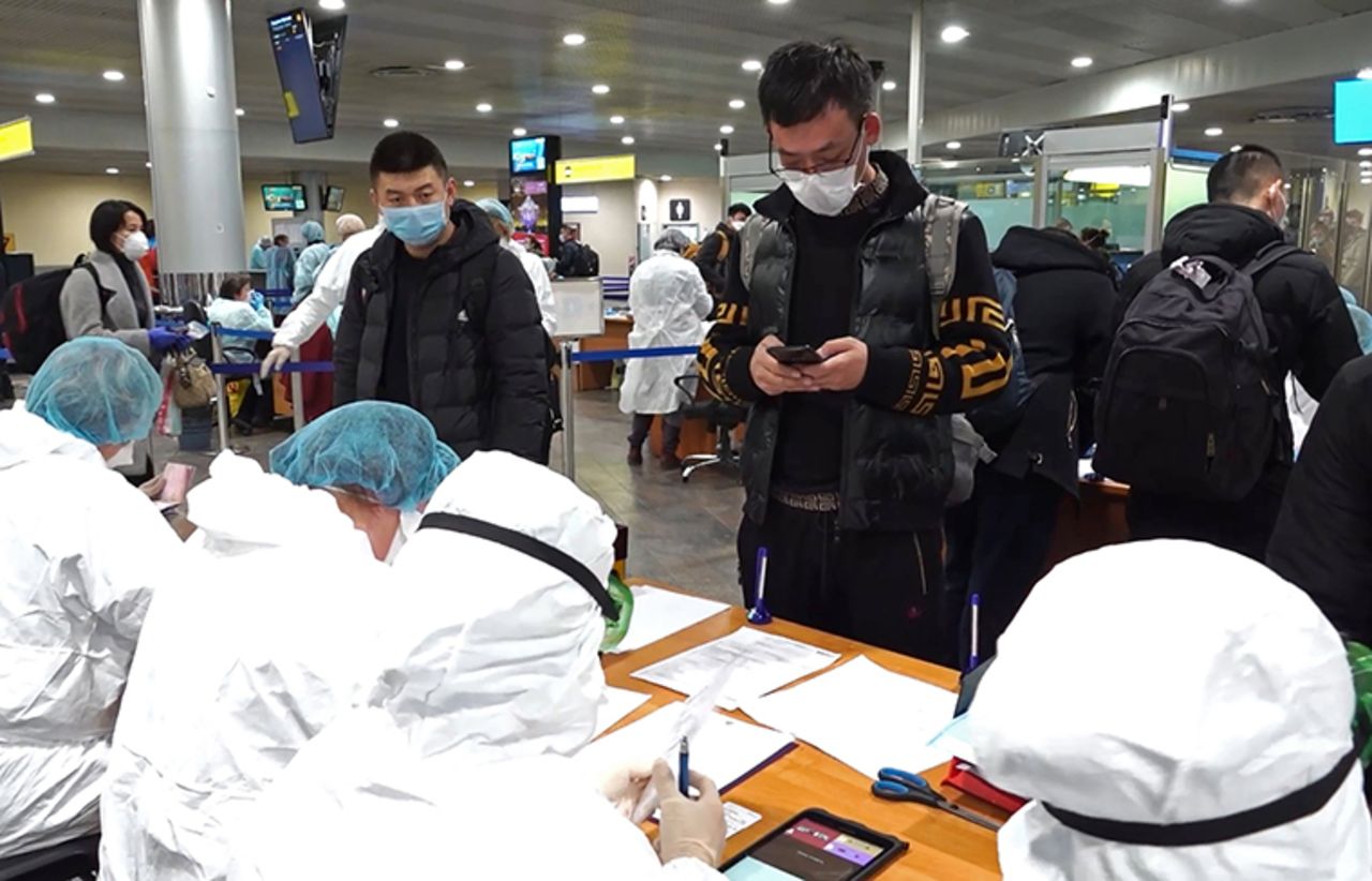 Passengers in face masks fill in special forms and have their temperature measured upon arival at Moscow's Sheremetyevo International Airport. As the airport tightens health security measures due to the novel coronavirus  outbreak, employees are checking passengers arriving from China, Italy, South Korea and Iran.